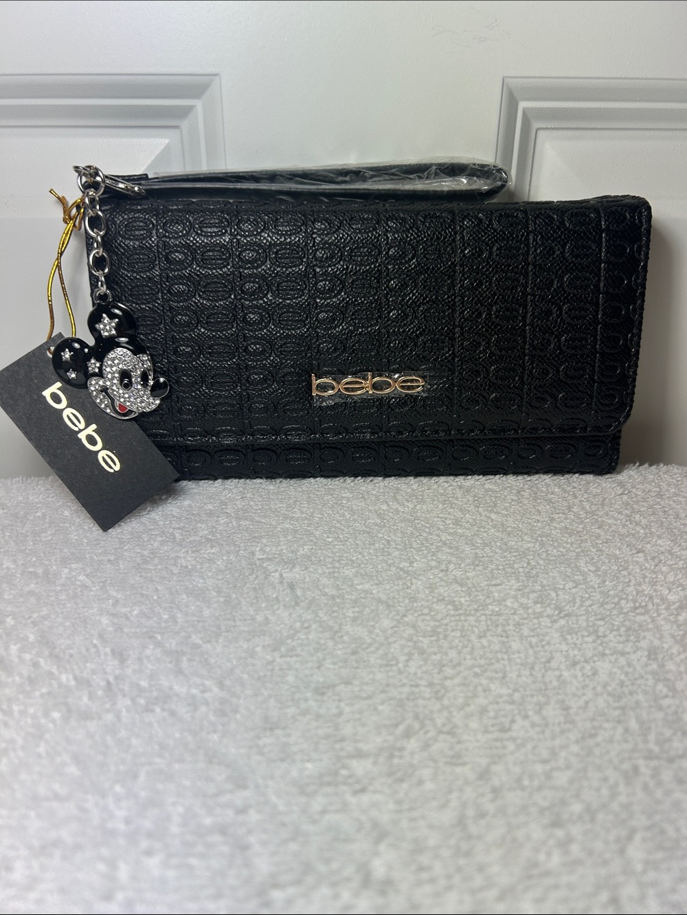 bebe Amaris Black Textured Wristlet Clutch with Rhinestone Character Charm